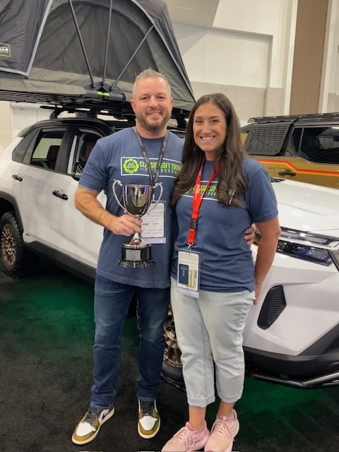 Ray and Jennifer Bedner holding the SEMA Cup trophy